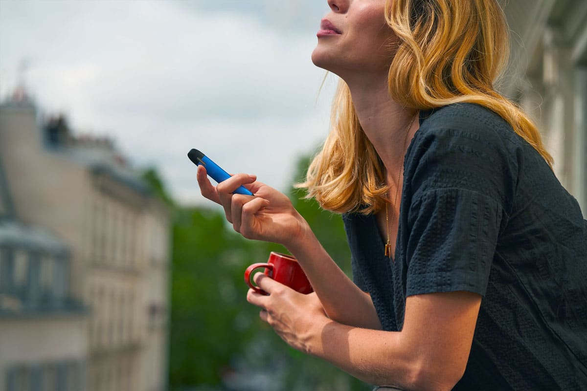 femme qui vapote une cigarette électronique jetable